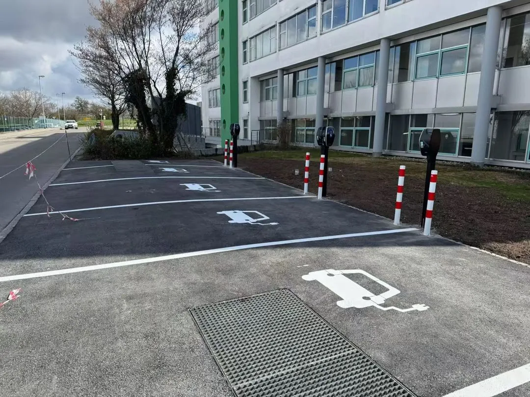 Neu markierte E-Ladeplätze mit Pollern auf einem Firmenparkplatz
